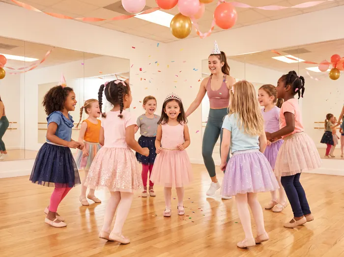 Kids dancing at a party with balloons
